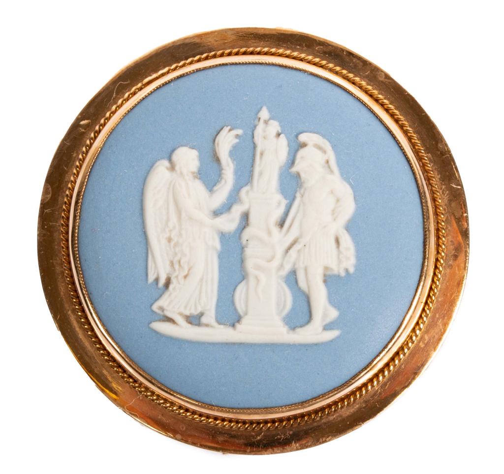 Wedgewood Jasper Cameo Pin Pendant: Item/Description: Antique Josiah Wedgewood jasper blue brooch framed in gold. Incised hallmark on reverse: Wedgewood Made in England / 70 S. English Hallmarks on rim of frame: WTT & Co. / 9-375 / anch