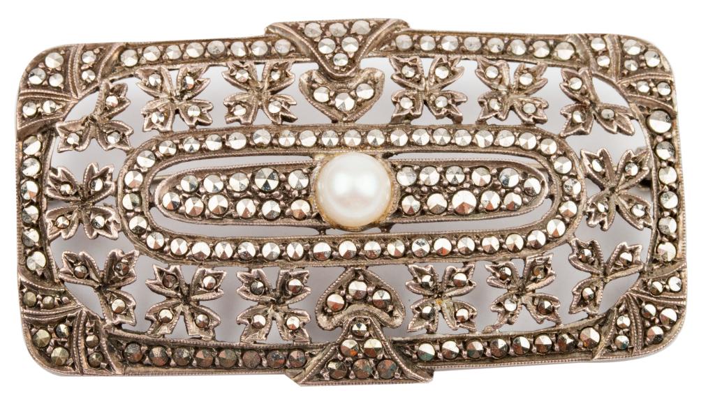 Antique Art Deco Silver Marcasite Pearl Brooch: Item/Description: Lovely antique contoured rectangular 935 Silver pin. Combines Art Nouveau and Deco elements. Geometric and flowering buds within a cut-out pierced mounting. Encrusted with hand-set s