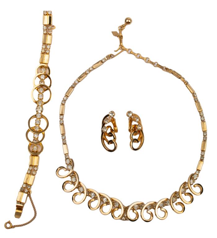 Sarah Coventry Modernist Parure: Item/Description: Lovely Mid-Century signed three-piece parure by Sarah Coventry includes an adjustable choker necklace, bracelet and clip earrings. Fashioned from high gloss gold tone metal, geometri