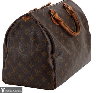 Louis Vuitton France Monogram Speedy 35 Handbag: Item/Description: Luxury French designer Louis Vuitton brown monogram leather Speedy 35 tote bag SP0057. Made in France in 1997. Iconic monogram PVC exterior and soft calf leather tabs. Double handled