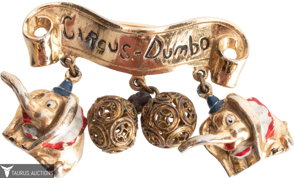 Coro Walt Disney Productions Circus-Dumbo Pin: Item/Description: Iconic Coro Walt Disney Productions Circus-Dumbo figural pin. Gold plated metal. Furled banner announcing Circus Dumbo. The brooch features two smiling Dumbo elephants decorated with