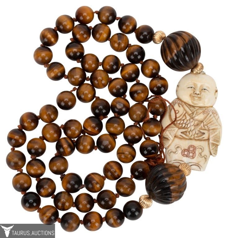 Japanese Netsuke Tiger's Eye Bead Necklace: Item/Description: Luminous over the head Tiger's Eye Netsuke rope necklace. The necklace is comprised of highly polished round Tiger's Eye stone beads, hand-knotted on colored twine. Four 14k gold bal