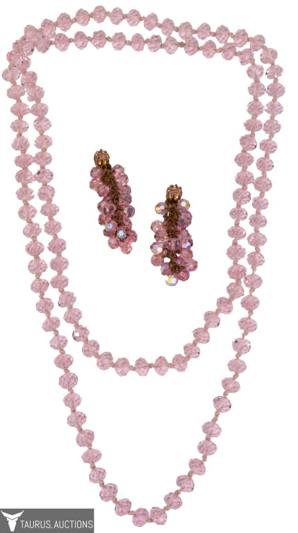 Pink Crystal Jewelry Lot: Item/Description: Scintillating pink crystal lot includes an over-the-head necklace in pastel pink and a deeper hued pair of chandelier drop clip earrings. The necklace is a hand-knotted endless rope 