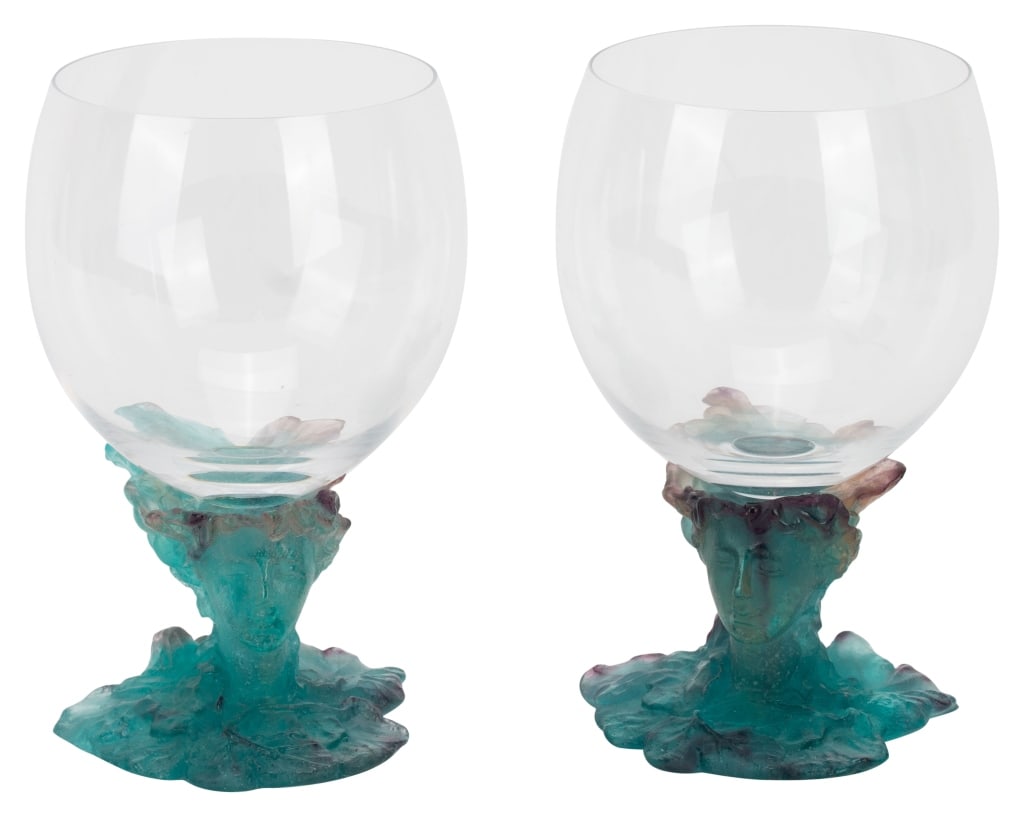 Pair Daum France "Bacchus" Goblets: Item/Description: Set of two Daum art glass Pate De Verre wine goblets. In The Bacchus Pattern Clear glass goblets mounted on a pate de verre stems in the form of a green man, and his lady, among grap