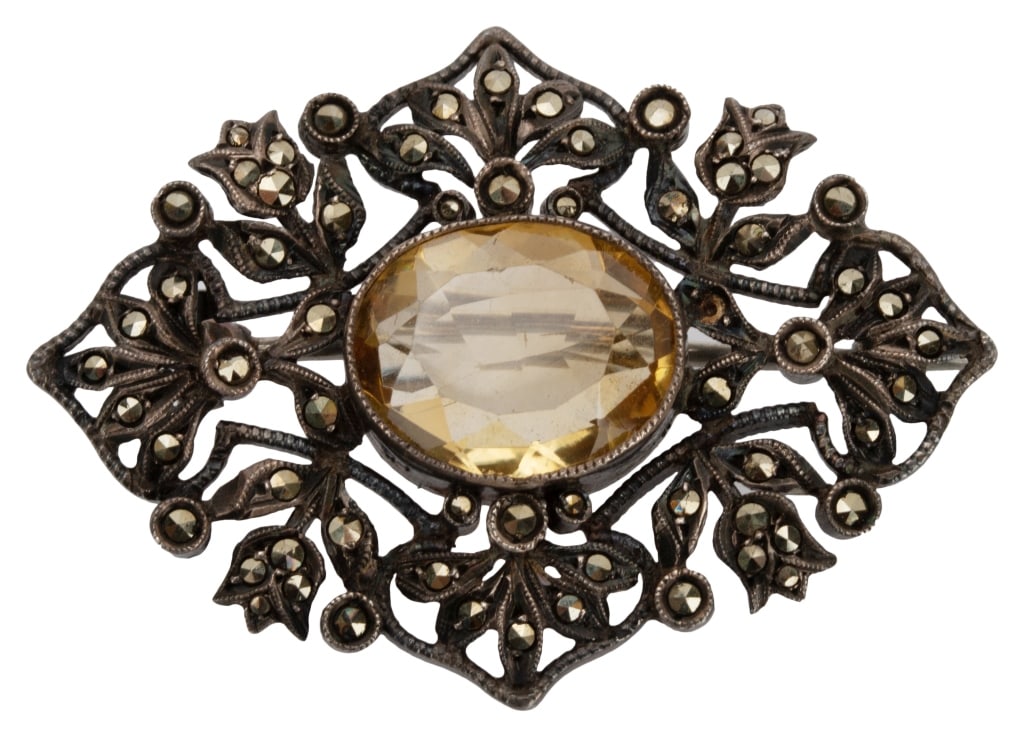 Antique Sterling Marcasite Citrine Gemstone Brooch: Item/Description: Lovely turn of the century antique brooch fashioned from Sterling Silver in a lacy pierce work design of flowers and leaves. Three dimensional design. Surface accented with sparkly, 
