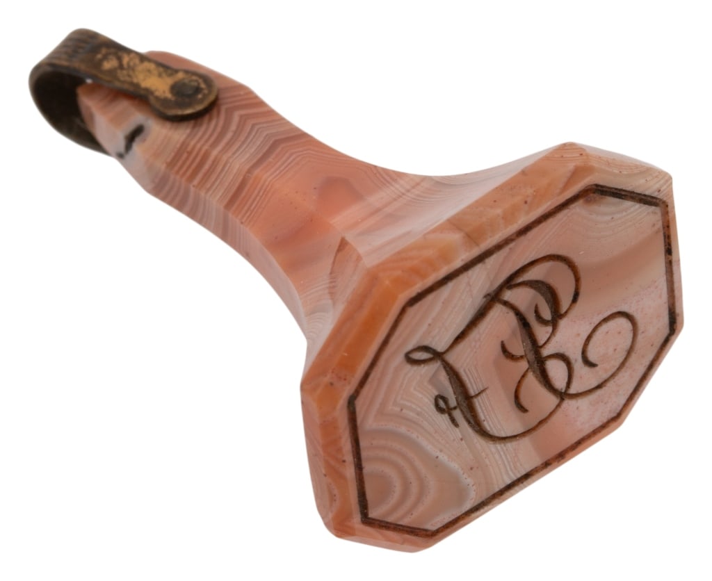 Antique Victorian Agate Stone Signet Pendant: Item/Description: Antique Victorian era banded agate stone signet pendant charm. Expertly carved and polished banded pink agate stone in a fluted shape. Tapered neck, hexagonal base. Incised with blac