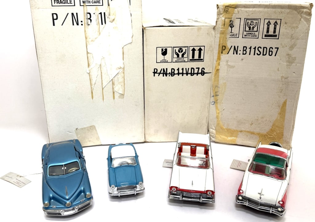 Franklin Mint Diecast Car Models: Item/Description: Four classic diecast model cars, with their original packaging boxes, manufactured in the 1990s. Features a blue 1948 Tucker Torpedo (1:24), a two-tone blue and white 1956 Nash Metro