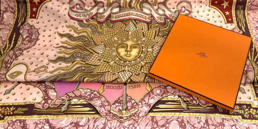 Hermes Paris Silk Scarf "Gloria Soli": Item/Description: Luxury designer Hermes "Gloria Soli" screen printed silk scarf, first designed by Joachim Metz in 1994. The vibrant and intricate design features a radiant, crowned sun motif and