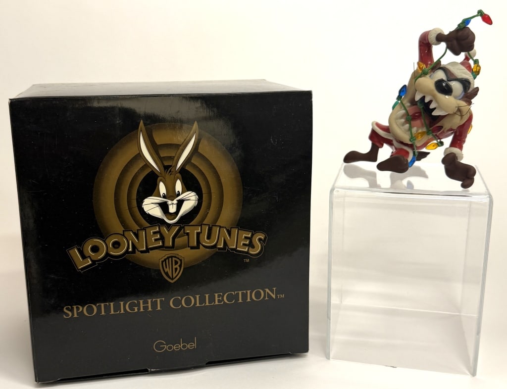 Looney Tunes Taz Christmas Ornament: Item/Description: Warner Bros. Looney Tunes Goebel Spotlight Collection "And To All A Good Bite" figurine featuring the Tasmanian Devil (Taz). The figurine depicts Taz dressed as Santa Claus and