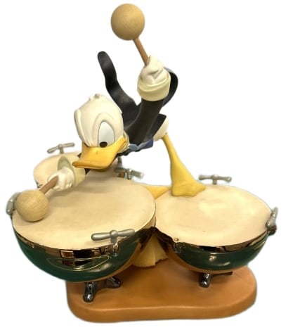 Classic Disney Donald Duck Porcelain Figurine: Item/Description: Walt Disney Classics Collection (WDCC) "Donald's Drum Beat" figurine, inspired by the 1942 animated short film Symphony Hour. The piece depicts Donald Duck enthusiastically playing a