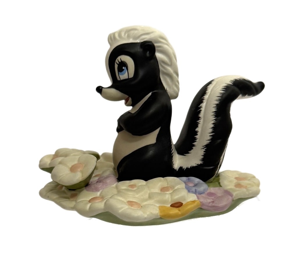 Disney Classics Bambi Skunk "Oh..gosh!" Figurine: Item/Description: Walt Disney Classics Collection (WDCC) "Oh... Gosh!" figurine of the Flower the Skunk character sitting on a bed of pastel-colored flowers, from the 1942 animated Disney film,