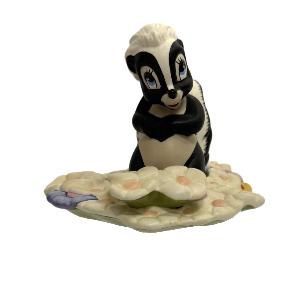 Disney Classics Bambi Skunk "Oh..gosh!" Figurine: Item/Description: Walt Disney Classics Collection (WDCC) "Oh... Gosh!" figurine of the Flower the Skunk character sitting on a bed of pastel-colored flowers, from the 1942 animated Disney film, Bambi.