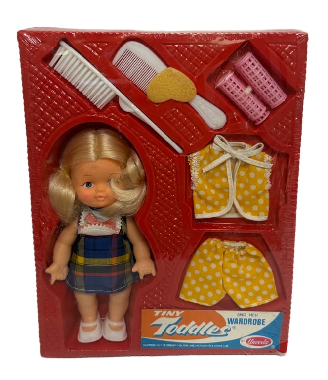 Tiny Toddles & Her Wardrobe Vintage Doll Set: Item/Description: Vintage "Tiny Toddles and Her Wardrobe" doll set, Model #71150, manufactured by Uneeda Doll Company, circa 1977, from "The Two of Us" series. The set includes a miniature blonde plas