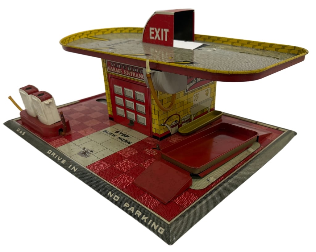 Mettoy Tin Litho Gas Service Station Toy: Item/Description: Mid-20th century lithographed tinplate garage playset manufactured by the Mettoy Company in Northampton, England. The toy features detailed printed graphics including brick and