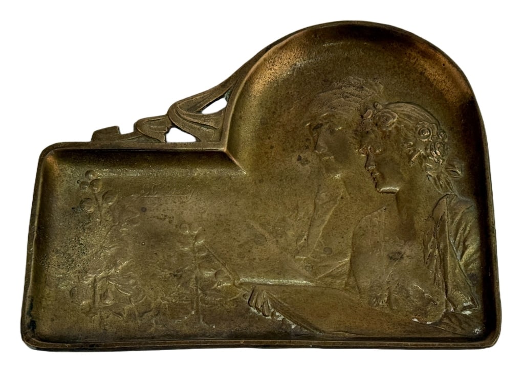 Brass Relief Art Nouveau Calling Card Tray: Item/Description: Art Nouveau brass calling card tray. Relief scene depicts two young women reading a book alongside some flowers. Worn marking above flowers possibly reads Germany. (Decorative