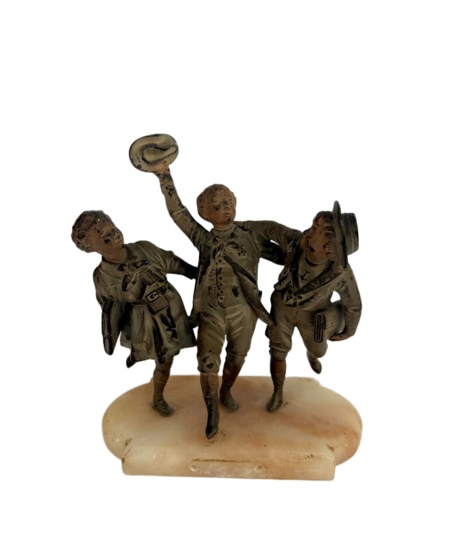 Bronze Grouping After De Brousse: Item/Description: Cold painted bronze figural grouping depicting three schoolboys in period clothing. En Vacances. Raised on shaped onyx plinth base. Missing front plaque. Attributed to Vincent Desire
