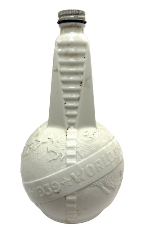 1939 World's Fair Milk Glass Souvenir Bottle: Item/Description: Vintage 1939 New York World's Fair milk glass souvenir bottle. It features an Art Deco design with an embossed globe and the text "1939 World's Fair". The bottle was originally used