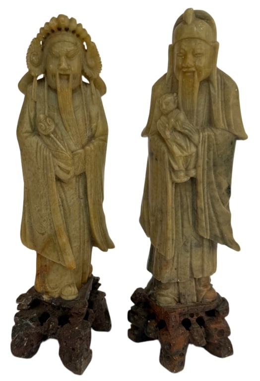 Set of Two Chinese Soapstone Deity Carvings: Item/Description: Chinese soapstone carvings, depicting deities of wisdom and longevity. The figures are depicted in the traditional manner of a bearded elderly men with a staff carrying smaller figur