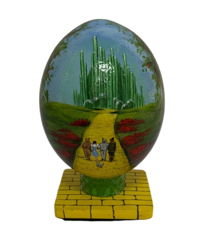 Phyllis Fitzpatrick Hand-Painted Wizard of Oz Egg: Item/Description: Intricate hand-painted egg?depicting the iconic "Emerald City" scene from?The Wizard of Oz. Features Dorothy, the Scarecrow, the Tin Man, and the Cowardly Lion walking down