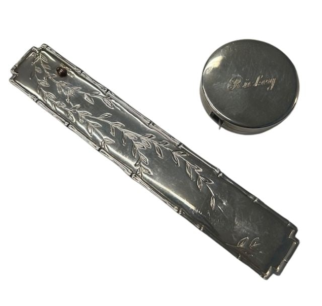 Tiffany & Co. Sterling 18K Bookmark, Tape Measure: Item/Description: This monogrammed Sterling Silver two piece lot by luxury maker, Tiffany & Company includes a bookmark and a 79" retractable measuring tape. Each monogrammed by the owner for "Rickey"