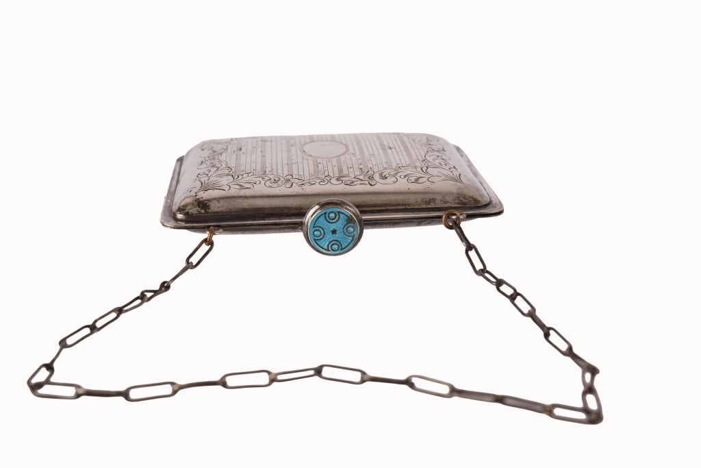 German Silver Guilloche Enamel Necessaire Purse: Item/Description: Antique 800 German Silver necessaire wristlet purse. Decorative chased front, with foliate scrollwork design and oval ready for a monogram. Hinged circular clasp closure accented