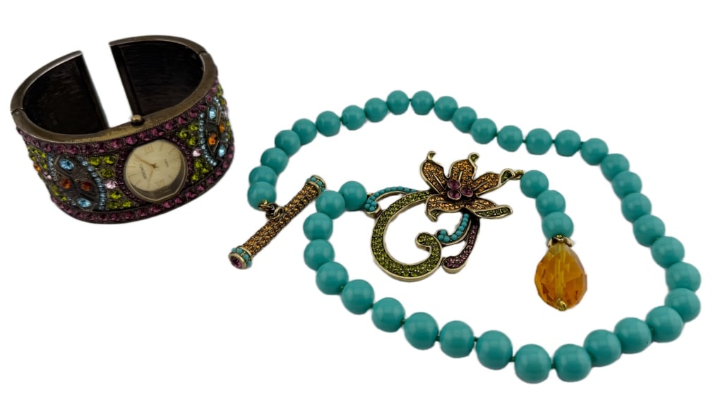 Heidi Daus Colorful Crystal Jewelry Lot: Item/Description: This signed lot by celebrated jewelry designer, Heidi Daus consists of a turquoise bead toggle necklace, known as the " Perrenial Favorite " and quartz watch cuff bracelet. Each