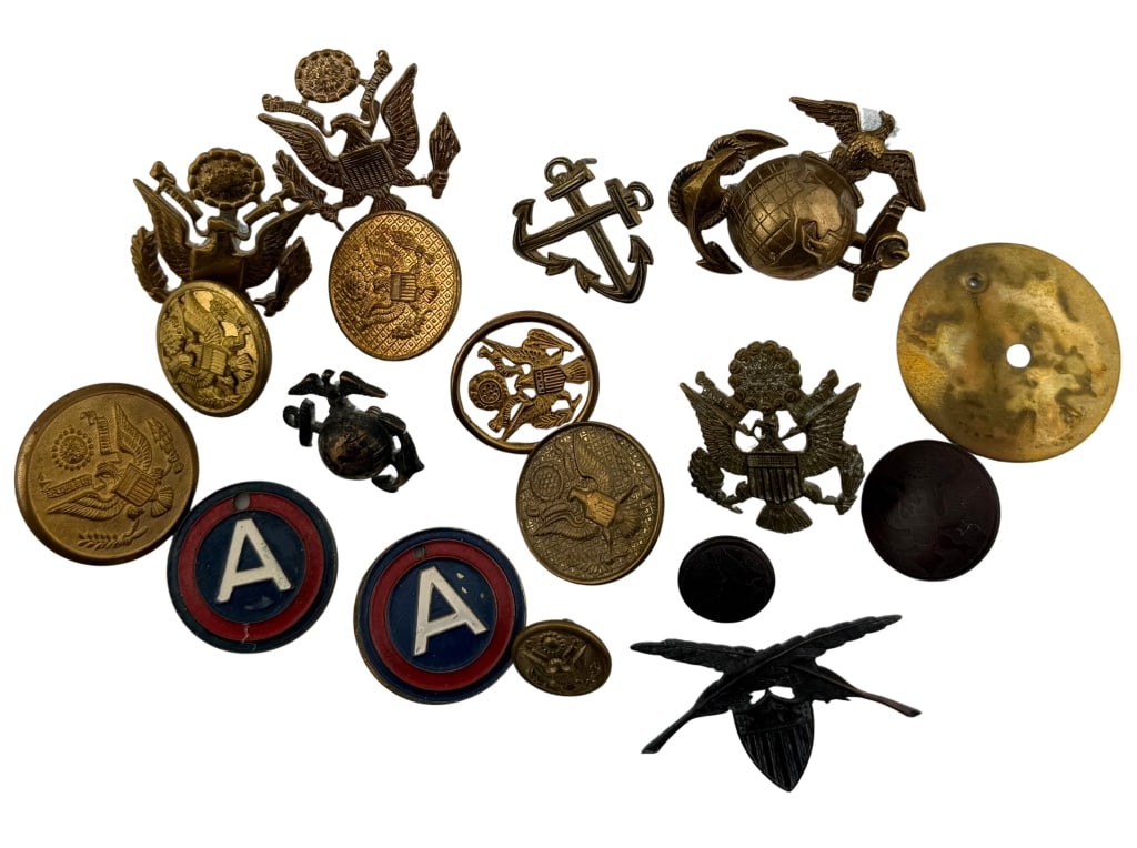 United States Military Insignia & Badges Lot: Item/Description: Lot of WWI - WWII era United States pins / badges. Includes 11 Great Seal uniform button / pins, 2 Marine Corps EGA insignia, Adjutant General's Corps branch insignia, Navy Warrant O