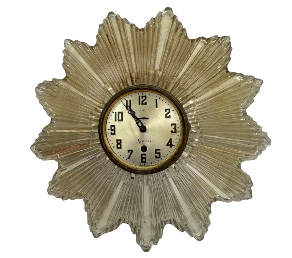 1930s Laurence Colwell Sunburst Glass Wall Clock: Item/Description: Heavy, architectural molded glass sunburst frame designed by Laurence Colwell. Bold radial ridges and a stylized, multi-point silhouette. Classic brass-bezeled dial featuring stylize