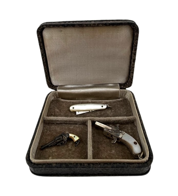 Antique Novelty Miniature Watch Fob Curiosity Set: Item/Description: Antique three-piece novelty curiosity watch fob set. Late 19th to early 20th century, circa 1890s-1910s. Miniature set features two miniature mechanical toy gun models alongside a