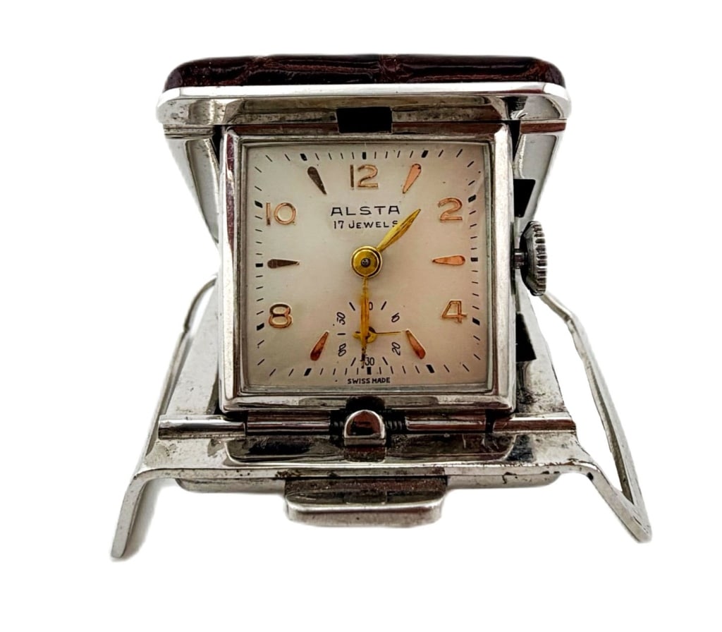 Mid-Century Alsta 17-Jewel Swiss Travel Clock: Item/Description: Vintage mid-century Alsta Swiss-made 17-jewel mechanical travel clock featuring a square cream dial with applied gold Arabic hour numerals, leaf hands, and a 6 o'clock alarm