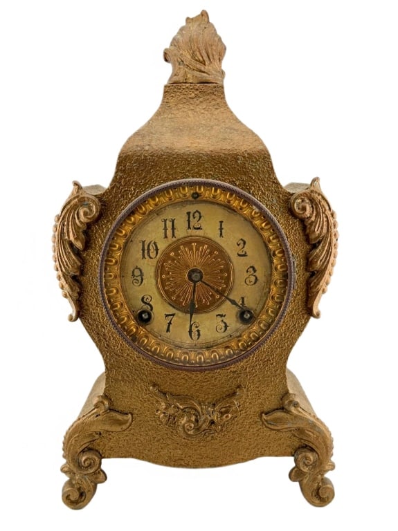 Ansonia Clock Co. Ornate Mantel Clock: Item/Description: Ansonia Clock Company, late 19th-century cast-metal mantel clock featuring a textured gilt finish and elaborate scrollwork in a Rococo Revival style. The interior brass movement is