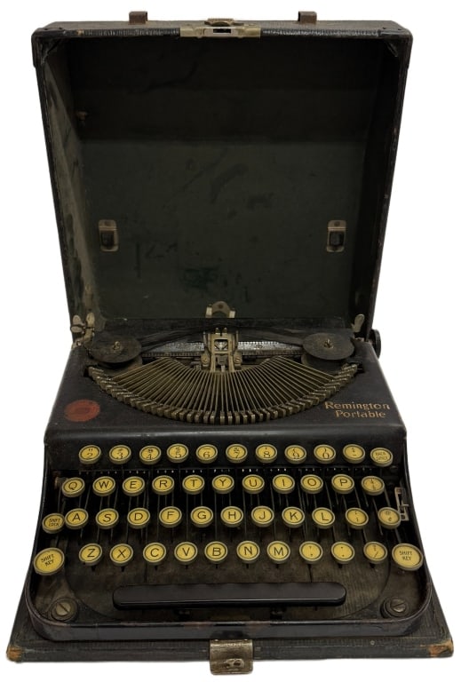 1920s Remington Portable Model 1 Manual Typewriter: Item/Description: Early 1920s Remington Portable Model 1 manual typewriter featuring a matte black enamel chassis, an innovative gear-driven folding typebar mechanism operated by side levers, and a co