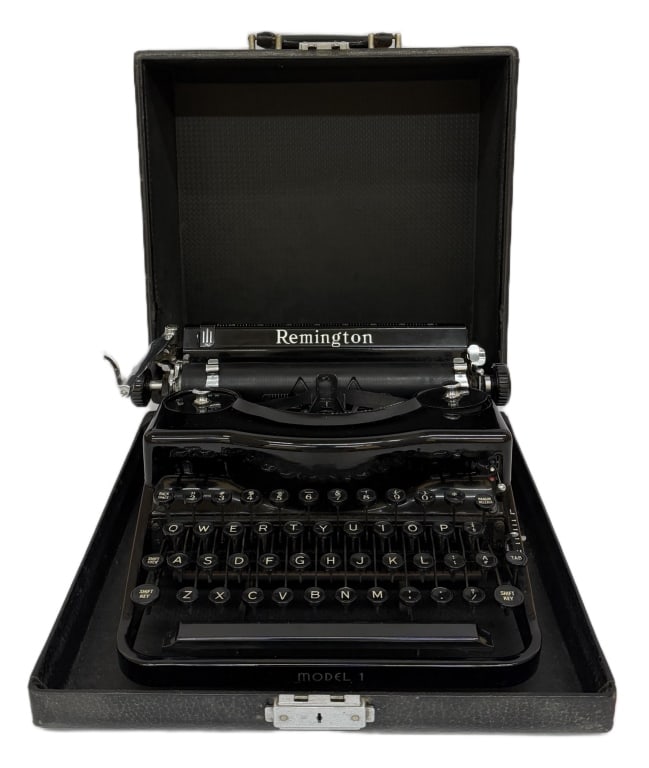 1930s Remington Model 1 Portable Manual Typewriter: Item/Description: Early 1930s Remington Model 1 manual portable typewriter features a high-gloss black enamel body, accented by polished chrome hardware and a complete four-bank layout of circular gla