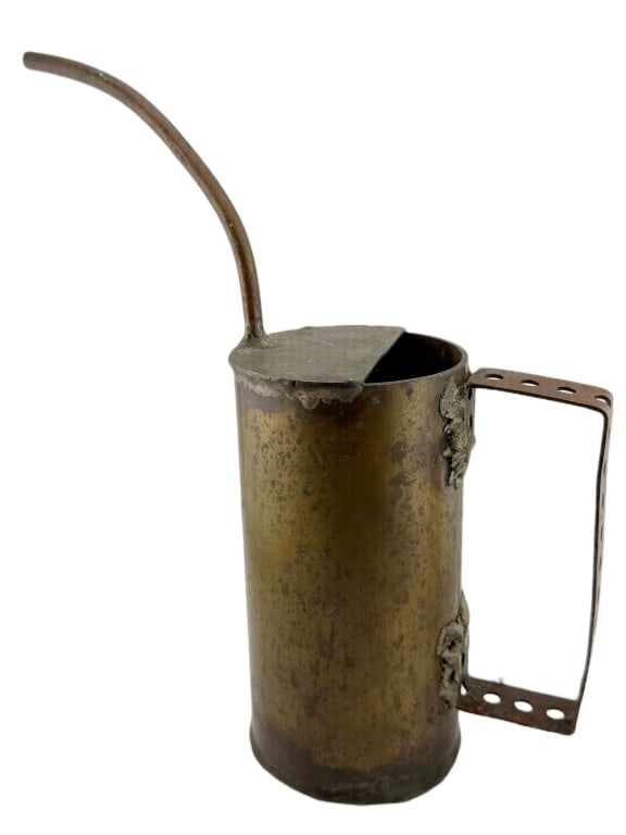 WWII Military Trench Art Artillery Shell Oil Can: Item/Description: WWII military trench art machinist oil can made from a fired brass artillery shell casing. Curved copper spout is attached to the top plate, and a strap-metal handle with punched ven
