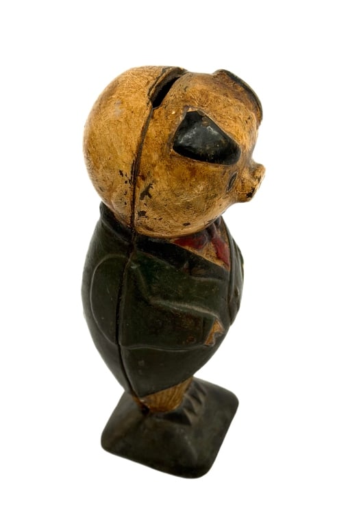 Antique Cast Iron Anthropomorphic Piggy Bank: Item/Description: Antique heavy cast iron still bank, cast in the distinct form of an anthropomorphic standing gentleman banker pig outfitted in a formal dark jacket, waistcoat, and red bow tie. Popul