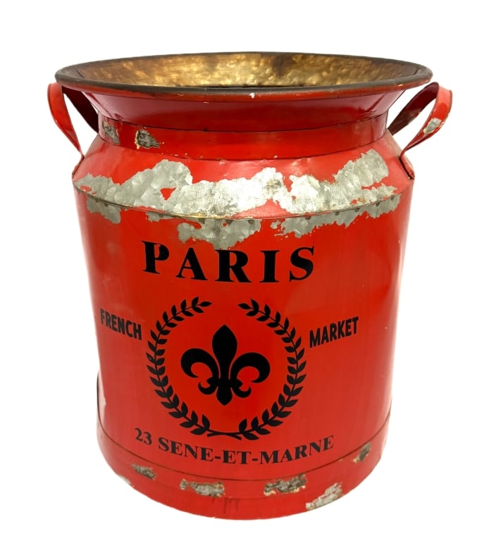 French Market Country Style Metal Milk Can: Item/Description: Decorative metal container fashioned in the classic silhouette of a French country milk churn, featuring a vibrant red exterior finish adorned with a black fleur-de-lis crest and ste