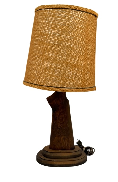 Mid-Century Gunstock Table Lamp: Item/Description: Vintage folk-art gunstock table lamp crafted by upcycling a solid wood rifle or shotgun stock into a sculptural lamp base. Mid-century style woven jute burlap drum shade. (Hunting Ca