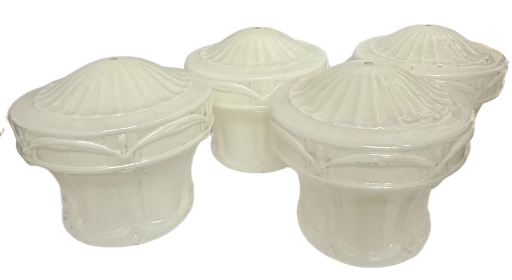 Art Deco Milk Glass Light Shades Grouping: Item/Description: Set of four milk glass light shades / post caps featuring ribbed domed tops and paneled bases with geometric detailing. Each shade includes a central mounting hole and a glossy opali