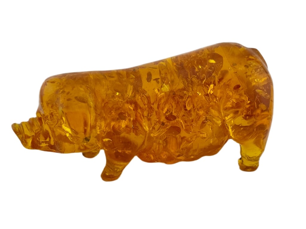 Amber-Hued Pressed Art Glass Pig Figurine: Item/Description: Art glass pig figurine. Made to mimic Baltic amber, it features internal fractures, bubbles, and variegated honey-gold inclusions. Unknown maker. No noticeable makers marks. Material