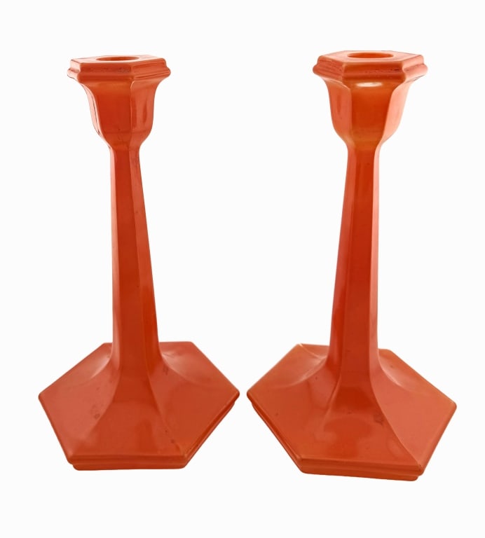 Art Deco Orange Tango Glass Candlesticks: Item/Description: Art deco Tango vibrant opaque orange glass candlesticks with a hexagonal base. Geometric pair have remnants of black detailing at the rim, a common motif of Tango glass. There is a f