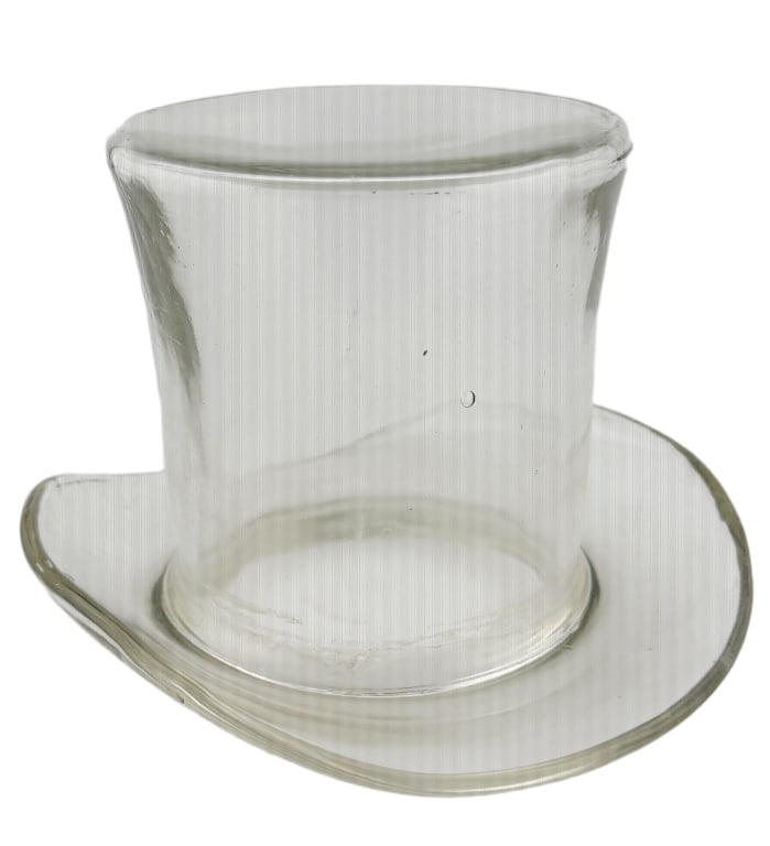 Blenko Hand-Blown Glass Top Hat Vase: Item/Description: American mid-century art glass vessel shaped in the form of a classic gentleman's figural top hat. Hand-blown from thick, heavy, clear glass, the piece features an undulating brim an