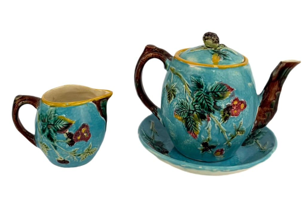 Continental Majolica Teapot, Creamer & Plate Set: Item/Description: Glazed earthenware set features a blackberry and vine design in relief on a bright blue ground, with branch-form handles to lidded teapot and creamer. Dish has an impressed British R