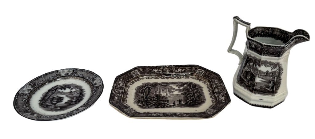 Three Staffordshire Black Transferware Pieces: Item/Description: Small collection of three English Staffordshire black transferware ironstone serving pieces. Includes: black mulberry transferware ironstone pitcher, ironstone platter featuring the