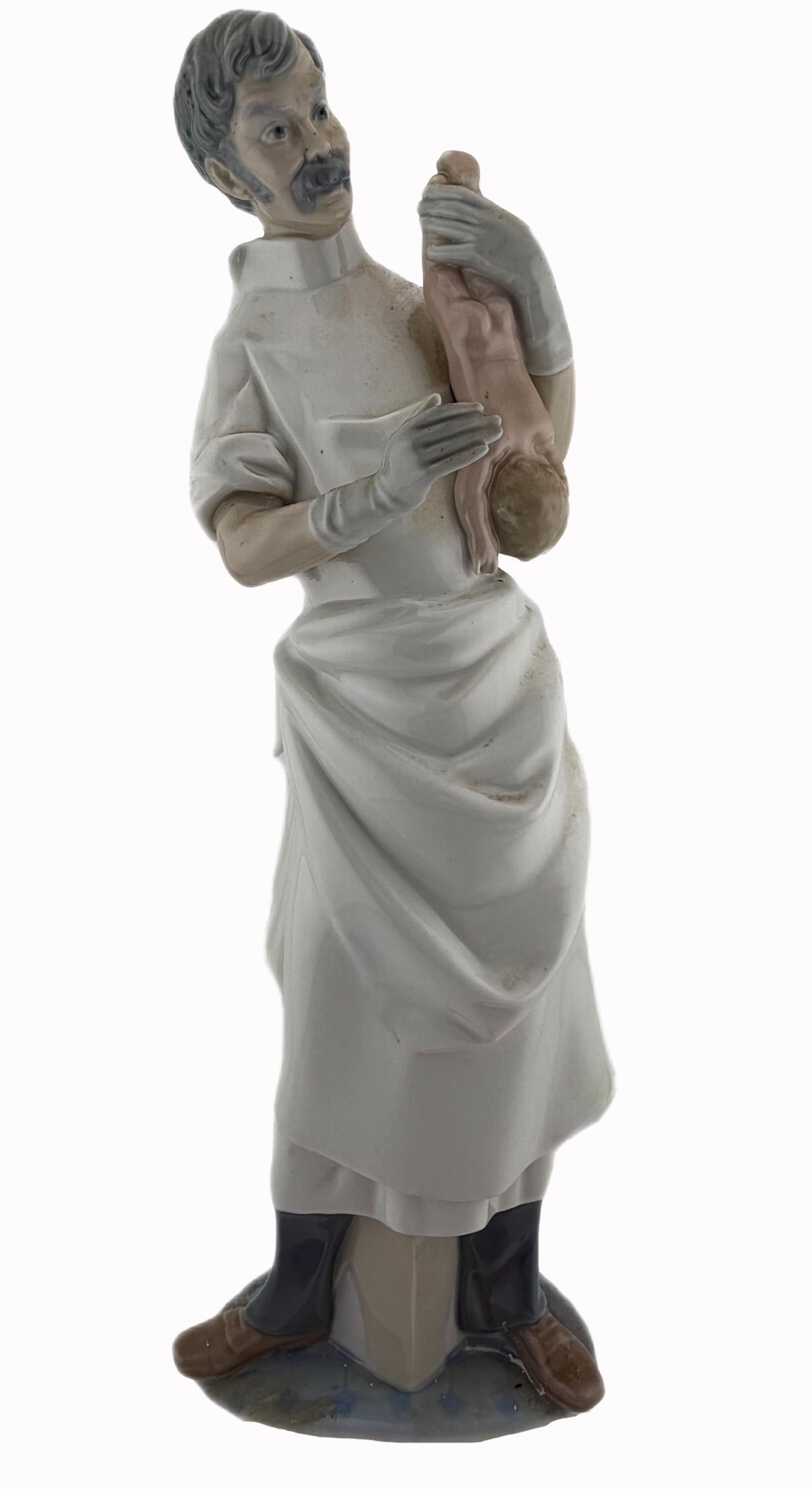 Lladro Obstetrician Porcelain Figurine: Item/Description: Lladro fine porcelain occupational figurine titled "Obstetrician" (Model No. 4763). Sculpted by foundational master Salvador Furio. Issued in 1971, retired in 1998. Figurine depicts