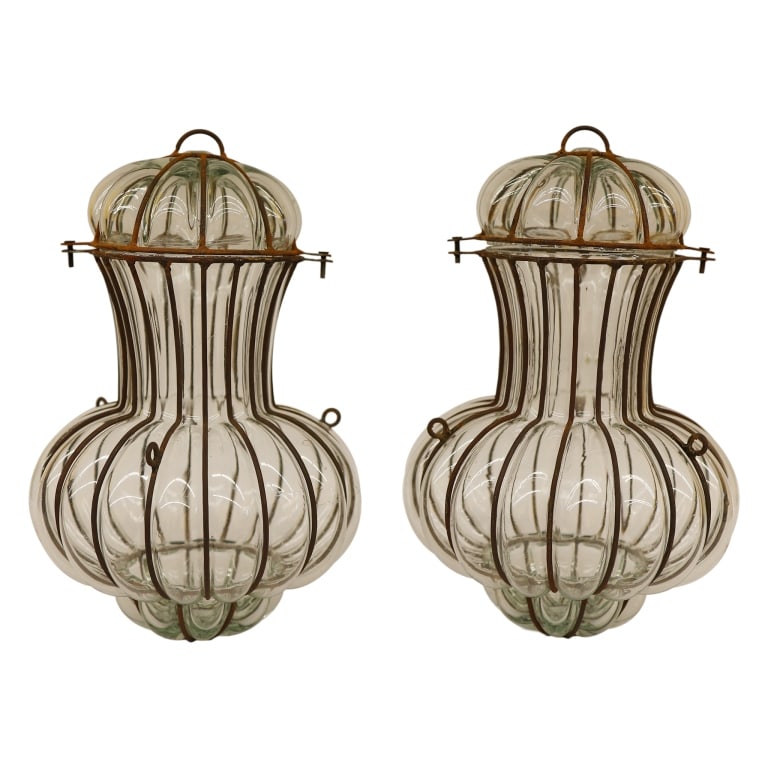 Pair of Venetian Caged Glass Onion Lanterns: Item/Description: Set of two vintage mid-century Venetian Murano caged glass shades, styled after maritime "onion" lanterns. Featuring clear, art glass mouth-blown inside an iron cage frame, creating 