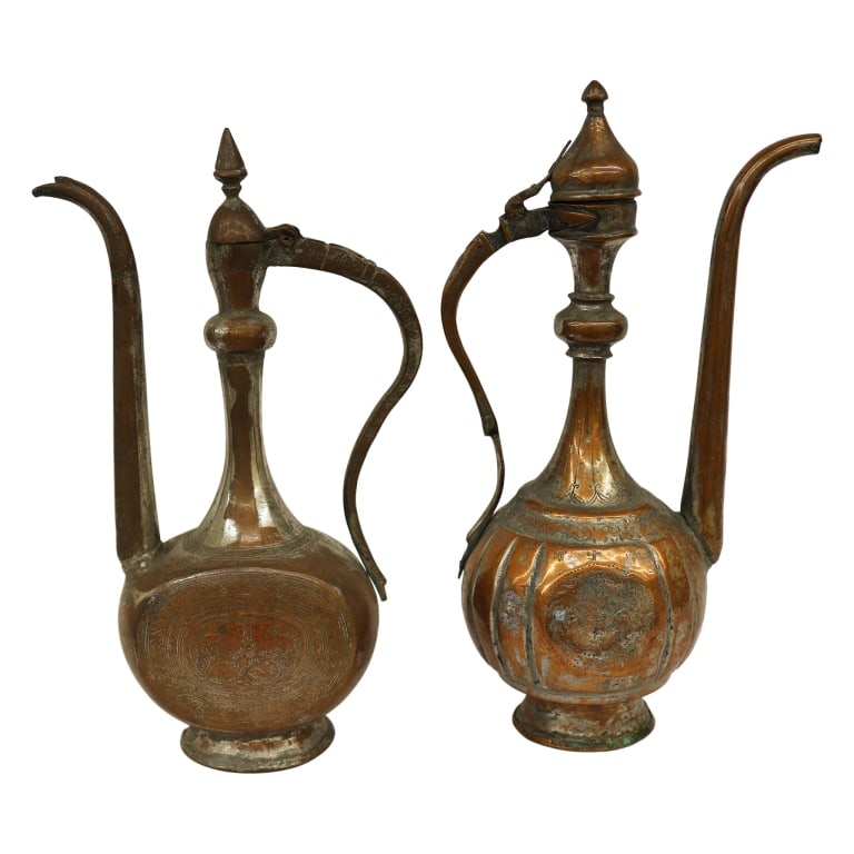 Islamic Copper Water Pitcher Pair: Item/Description: Two Middle Eastern / Indo-Persian Aftabas ewers. Hand-forged tinned copper vessels feature elongated spouts and architectural finial lids. Traditionally used in Islamic cultures for