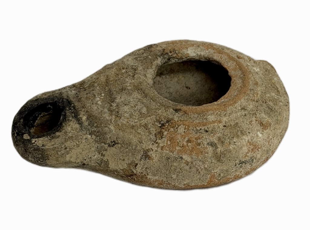 Ancient Byzantine Terracotta Oil Lamp: Item/Description: Authentic ancient pottery oil lamp featuring a rounded reservoir body transitioning to a tapered, extended wick nozzle. Exterior is heavily encrusted with genuine calcareous earthen 