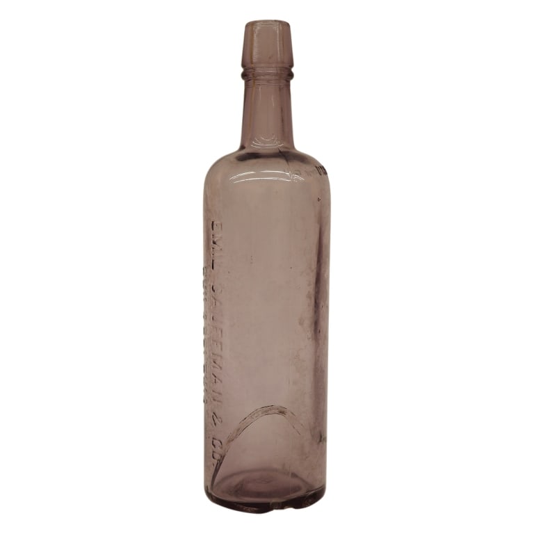 Kaufmann Sun-Purple Amethyst Glass Soda Bottle: Item/Description: An antique sun-purple amethyst glass Emil Kaufmann & Co. bottle, manufactured as a late 19th-century blown-and-molded cylindrical soda or water vessel with a crisp, multi-line horizo