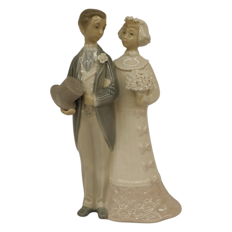 Lladro "Wedding of Yesteryear" Figurine: Item/Description: Lladro "Wedding" or "Wedding of Yesteryear" (#4808) porcelain figurine with a high-gloss glaze finish. Sculpted by esteemed artist Julio Fernandez. Issued in 1972 and retired from pr
