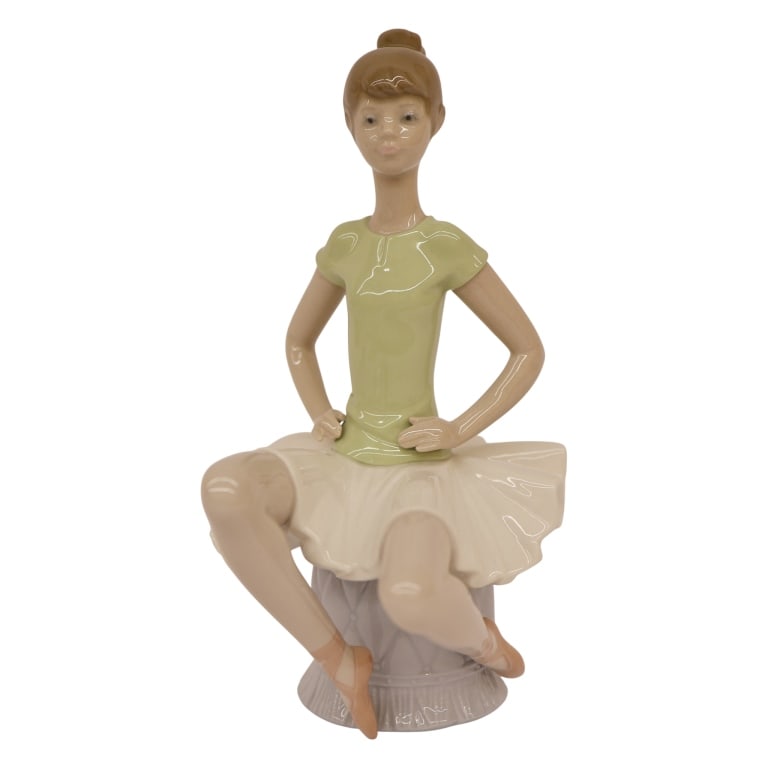 Lladro "Laura Ballerina" Figurine: Item/Description: Lladro "Laura Ballerina" (#1360) porcelain figurine, designed by Juan Huerta. Issued in 1978 and retired from production in 1994. Composition depicts a poised young ballerina seated 